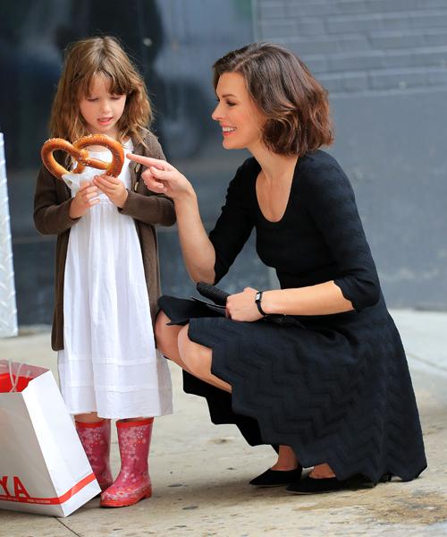 Milla Jovovich buys daughter Ever Gabo Anderson a pretzel in the Meatpacking District in NYC. Pictured: Milla Jovovich and Ever Gabo Anderson Ref: SPL391449  090512   Picture by: Jackson Lee / Splash News Splash News and Pictures Los Angeles:	310-821-2666 New York:	212-619-2666 London:	870-934-2666 photodesk@splashnews.com 