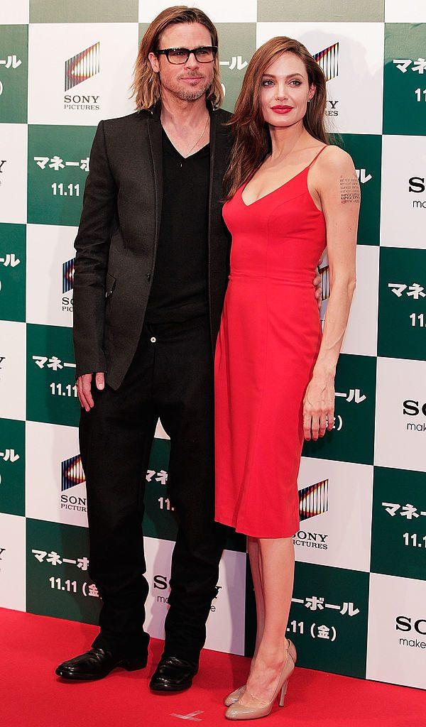 TOKYO, JAPAN - NOVEMBER 09: Brad Pitt and Angelina Jolie pose for a photograph on the red carpet during the "Moneyball" Japan Premiere at Tokyo International Forum on November 9, 2011 in Tokyo, Japan. (Photo by Adam Pretty/Getty Images)