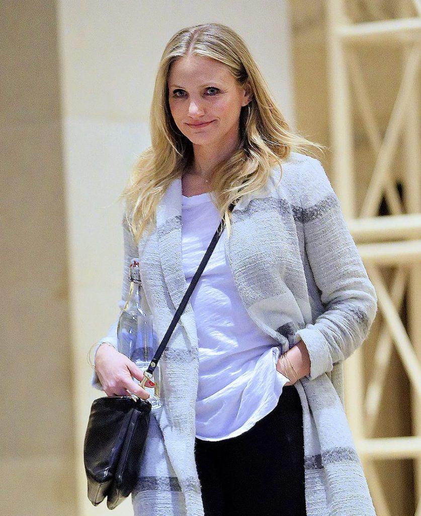Cameron Diaz carries a big water bottle when walking inside an office building with a smile in New York City, NY  Pictured: Cameron Diaz
