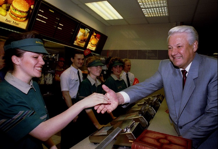 Russian President Boris Yeltsin (R) shakes hands with A cashier June 2 , while visiting the second M..